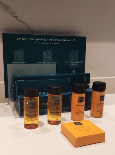 three bottles of essential oils next to a box at Silken Ciudad Gijón in Gijón