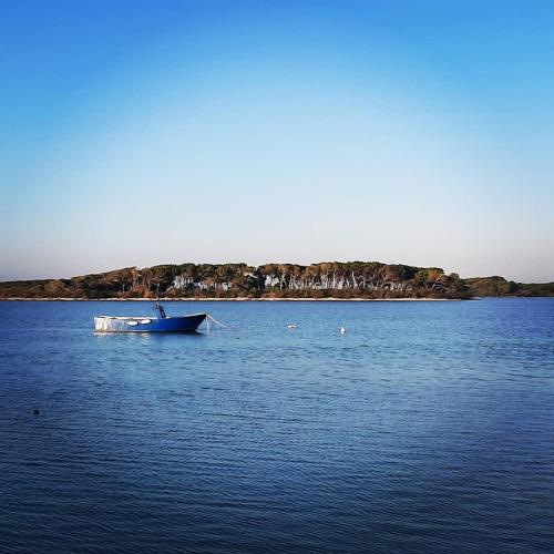 a boat sitting in the middle of a large body of water at Casina Pompiliano in Nardò