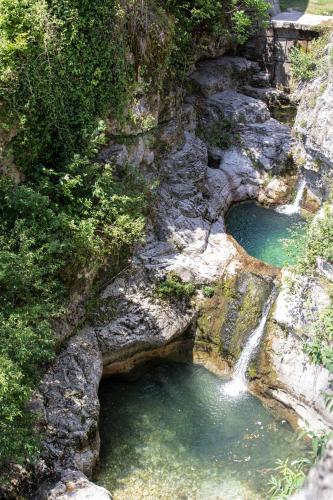 a pool of water on a rocky hillside at Alloggi I Calieroni in Valstagna