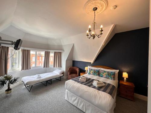 a bedroom with a bed and a chandelier at The Silver How in Bournemouth