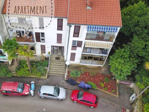 an aerial view of cars parked in front of a building at Alba Opatija in Opatija