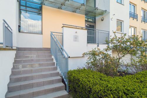 a stairway leading to a building with windows at Retro Style Apartment with Balcony near the Forest by Noclegi Renters in Gdynia