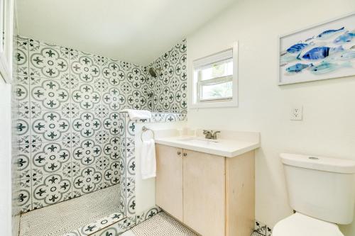 a bathroom with a toilet and a sink at Cast a Waves - Cute Beach Bungalow - Ocean Views - Walk to the Beach in Galveston