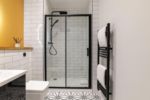 a shower with a glass door in a bathroom at * City Centre * Unique Space * in Aberdeen