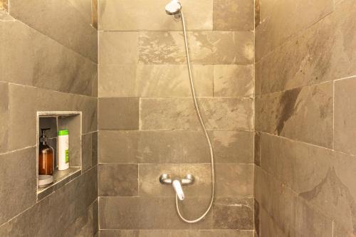 a shower with a hose in a bathroom at Calheta Beach House T2 in Calheta