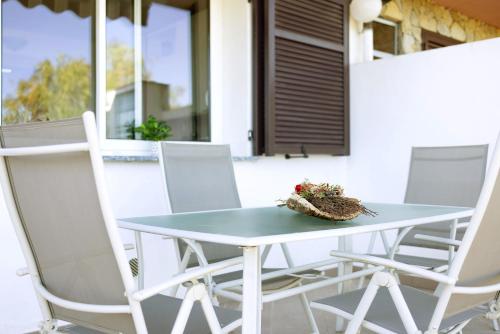 a table and four chairs on a patio at casa vacanza Sanaa in Civezza