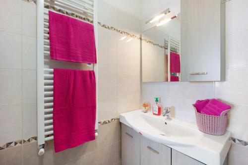 a bathroom with a sink and a red towel at casa vacanza Sanaa in Civezza