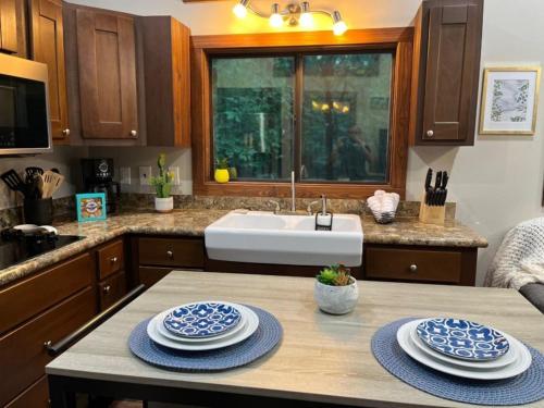 a kitchen with a table with blue and white dishes on it at Snuggle Up in Broken Bow