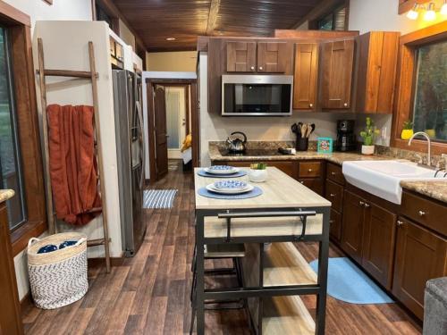a kitchen with a island in the middle of it at Snuggle Up in Broken Bow