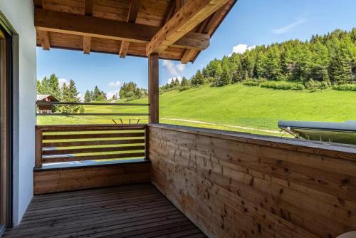 a balcony with a view of a green field at Ferienparadies Sabina Birke in Alpe di Siusi