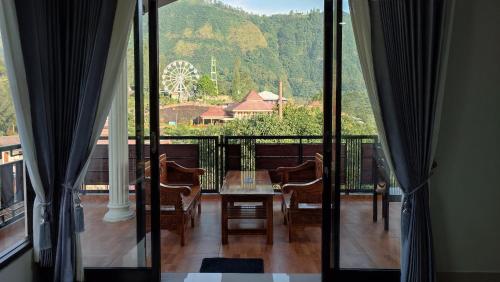 a balcony with a table and chairs and a view at Gubuk Ndeso Bromo in Bromo