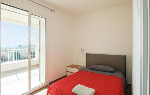a bedroom with a red bed and a large window at Stunning Home In Appignano Del Tronto With Wifi And 4 Bedrooms in Appignano del Tronto