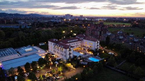 an aerial view of a city at night at Savoia Hotel Regency in Bologna