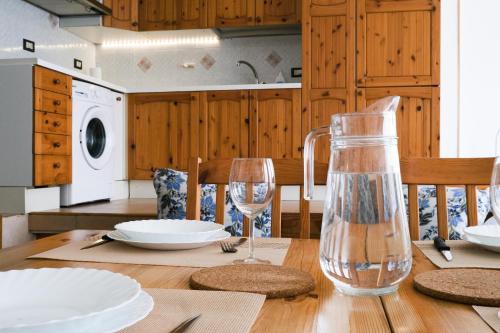 una mesa de comedor con una botella y vasos. en Casa Giuly en Crema