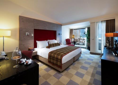 a hotel room with a bed and a balcony at Agaoğlu My City Hotel Istanbul in Istanbul