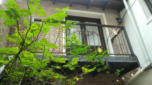 a window of a building with a iron balcony at Hotel Rivera in Colonia del Sacramento