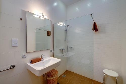 a white bathroom with a sink and a shower at Seaside Oasis Your Own Private Getaway in St Julians in St. Julianʼs