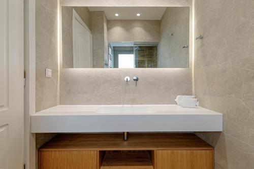 a bathroom with a white sink and a mirror at Kalami Beach - Villa Anastasia in Kalami