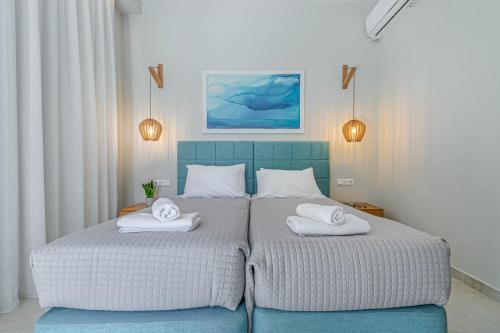 a bedroom with a bed with two towels on it at Kalami Beach - Villa Anastasia in Kalami