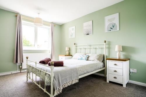 a bedroom with a white bed and a window at Cosy Nottingham City Centre Townhouse in Nottingham