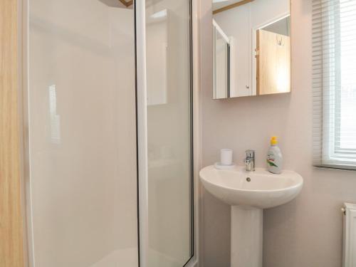 a white bathroom with a sink and a shower at Lodge 7 - Seabreeze Retreat in Bridlington