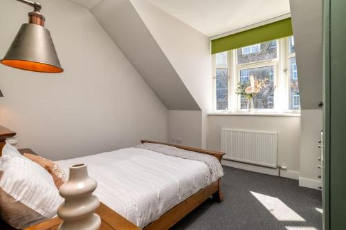 a bedroom with a bed and a window at Remodelled Luxury 3 Bed Apartment in Aberdeen