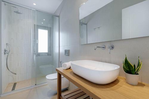 a bathroom with a large white sink and a toilet at Kalami Beach - Villa Mara in Kalami