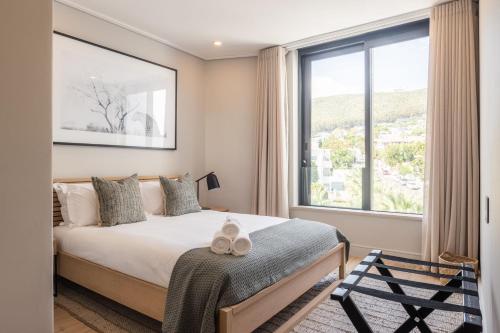 a bedroom with a bed and a large window at Casa on Kei by Totalstay in Cape Town