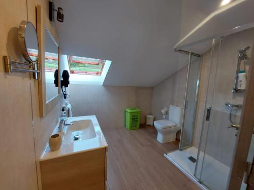 a bathroom with a sink and a shower and a toilet at Mirador do faro Touriñan in Muxia