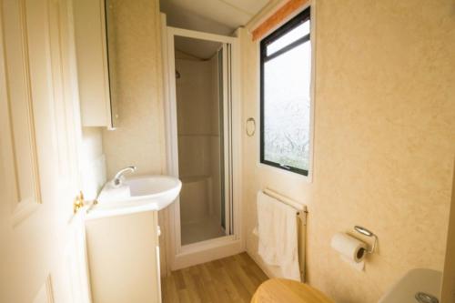 a bathroom with a sink and a shower at 6 Berth Caravan For Hire, Minutes From A Stunning Beach In Norfolk! Ref 21036f in Heacham
