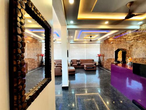 a living room with a couch and a fireplace at Hotel Golden Heights Gokarna in Gokarna