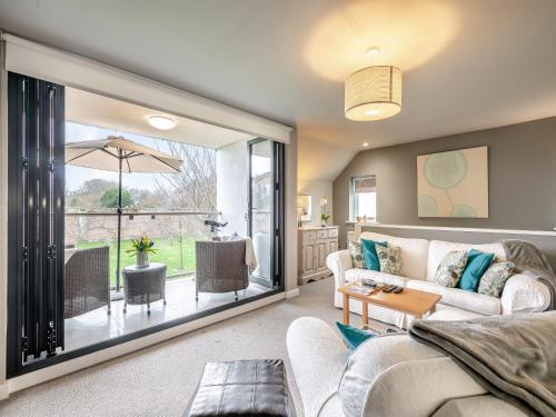 a living room with a couch and a table at The View in West Stow