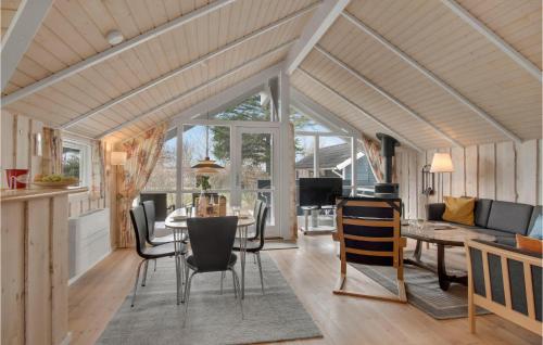 a living room with a table and chairs at Gorgeous Home In Slagelse With Sauna in Slagelse