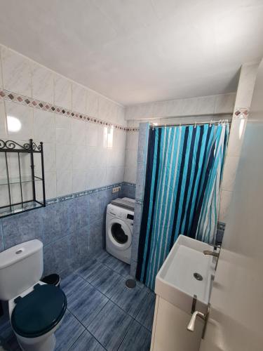a bathroom with a toilet a sink and a shower at Casa Eowyn in Puerto del Carmen