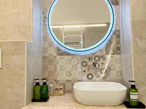 La salle de bains est pourvue d'un lavabo et d'un miroir. dans l'établissement Don Pietro - Pieno Centro Storico, à Ostuni