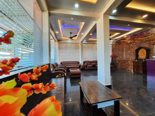 a lobby of a hotel with couches and a table at Hotel Golden Heights Gokarna in Gokarna