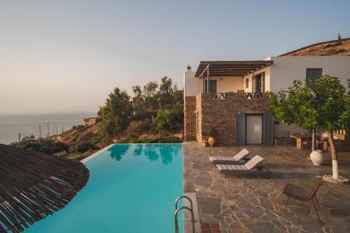 a villa with a swimming pool and a house at Kea Boho Luxury with Pool & Stunning Views in Melissaki