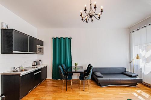 a kitchen with a couch and a table in a kitchen at My city apartment - Vienna CityRoom in Vienna