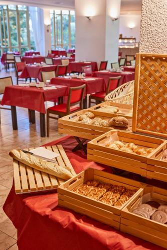 a table with trays of pastries in a restaurant at MLL Blue Bay in Palma de Mallorca