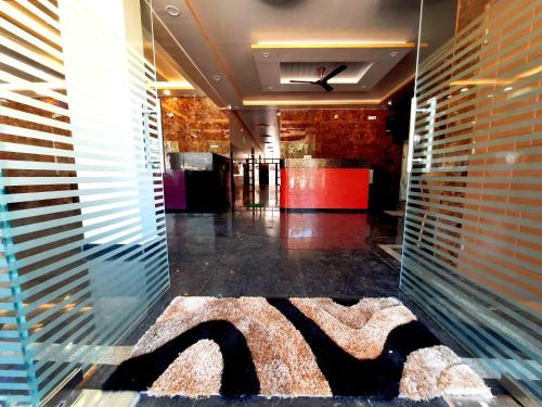 a lobby with a large rug on the floor at Hotel Golden Heights Gokarna in Gokarna