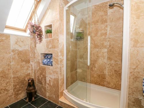 a shower with a glass door in a bathroom at 3 Lane End Court in Crewe