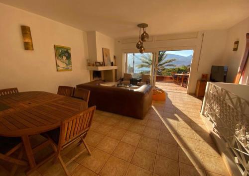 a living room with a couch and a table at Les Cactus in Bine el Ouidane