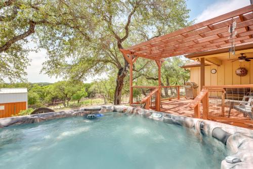 a swimming pool with a pergola and a house at Lodge at Rocky Creek with Private Hot Tub and Yard! in Canyon Lake