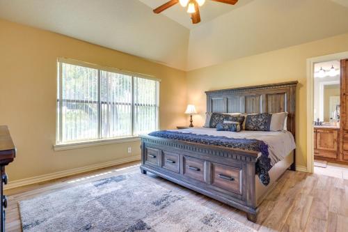 a bedroom with a large bed and a window at Lodge at Rocky Creek with Private Hot Tub and Yard! in Canyon Lake