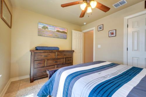 a bedroom with a bed and a ceiling fan at Lodge at Rocky Creek with Private Hot Tub and Yard! in Canyon Lake