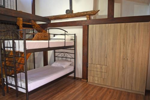 a bunk bed room with two bunk beds and a closet at The Stonewall House - at the old town of Samos in Vathý