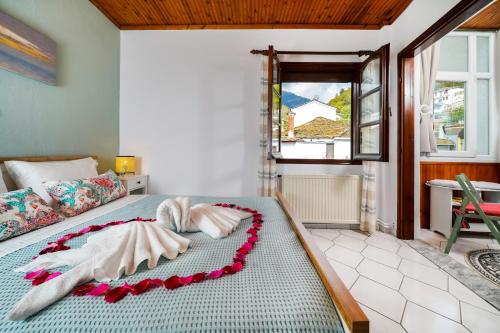 a bedroom with a bed with two towels on it at La Casa de Fokas - Village Home in Panayia