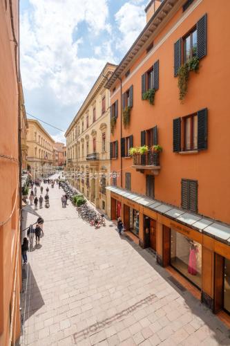 an empty street in a city with buildings at D'Azeglio & Galluzzi Suites in Bologna