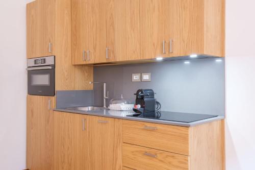 a kitchen with a counter top with a coffee maker at D'Azeglio & Galluzzi Suites in Bologna