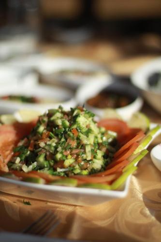 a plate of food with vegetables on a table at Bab Al Shams Resort in Jericho